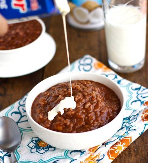 Filipino champorado in a bowl on a colorful napkin.