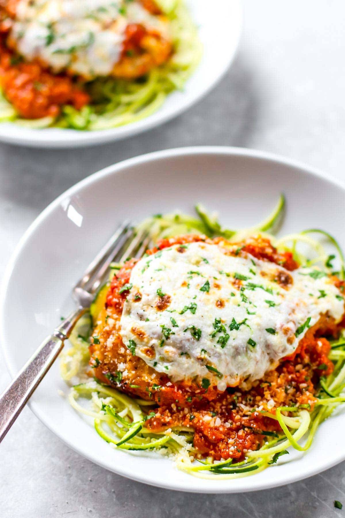 Chicken Parmesan on a white plate.