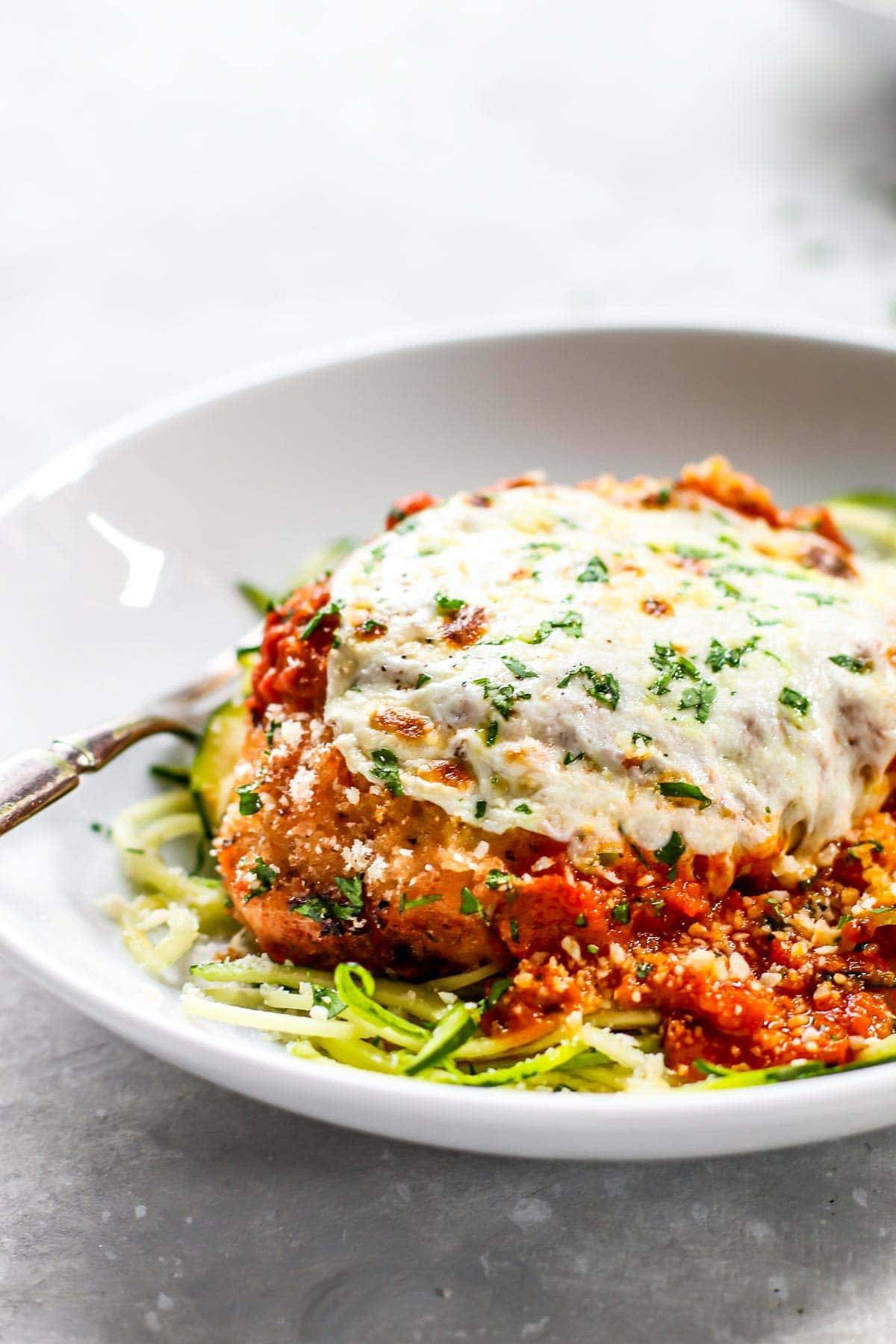 Chicken Parmesan on a white plate.