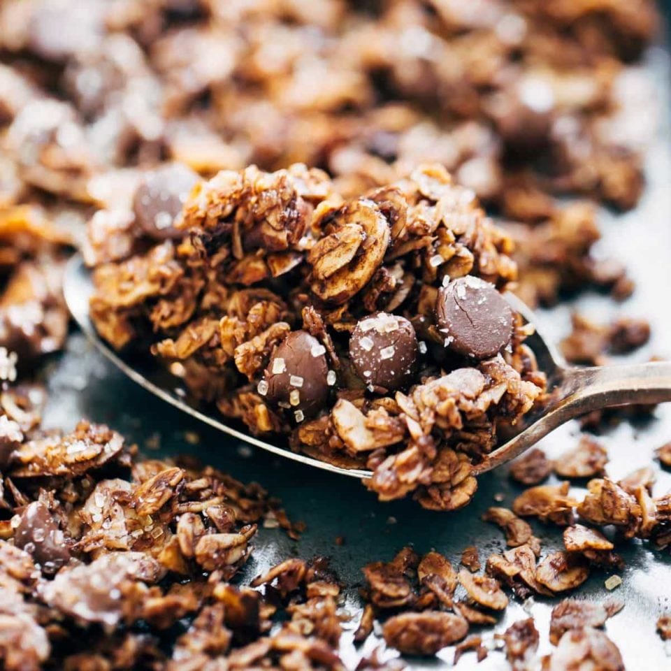 Spoonful of Chocolate Granola on a baking sheet.