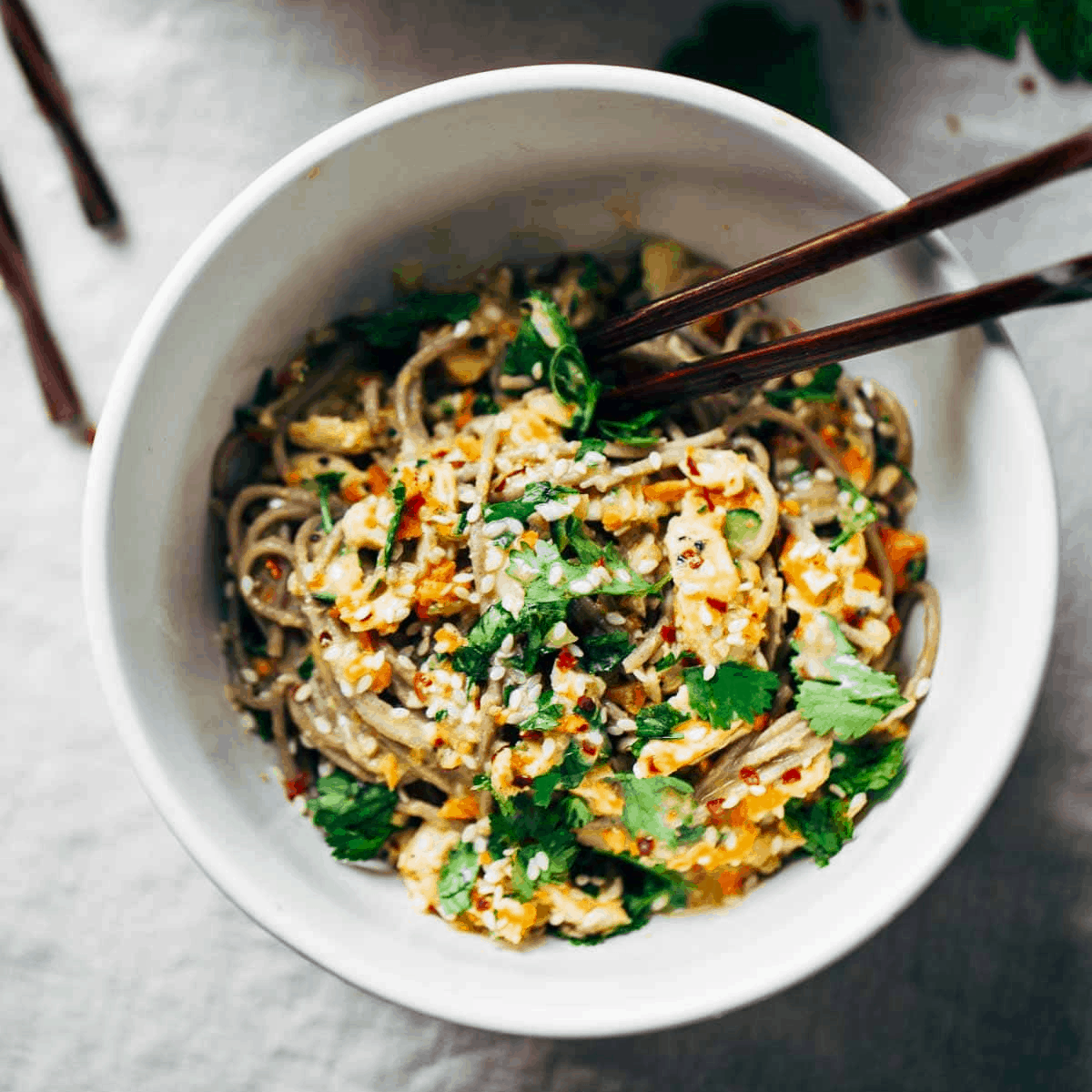 Chopped Chicken Sesame Noodle Bowl with chopsticks.
