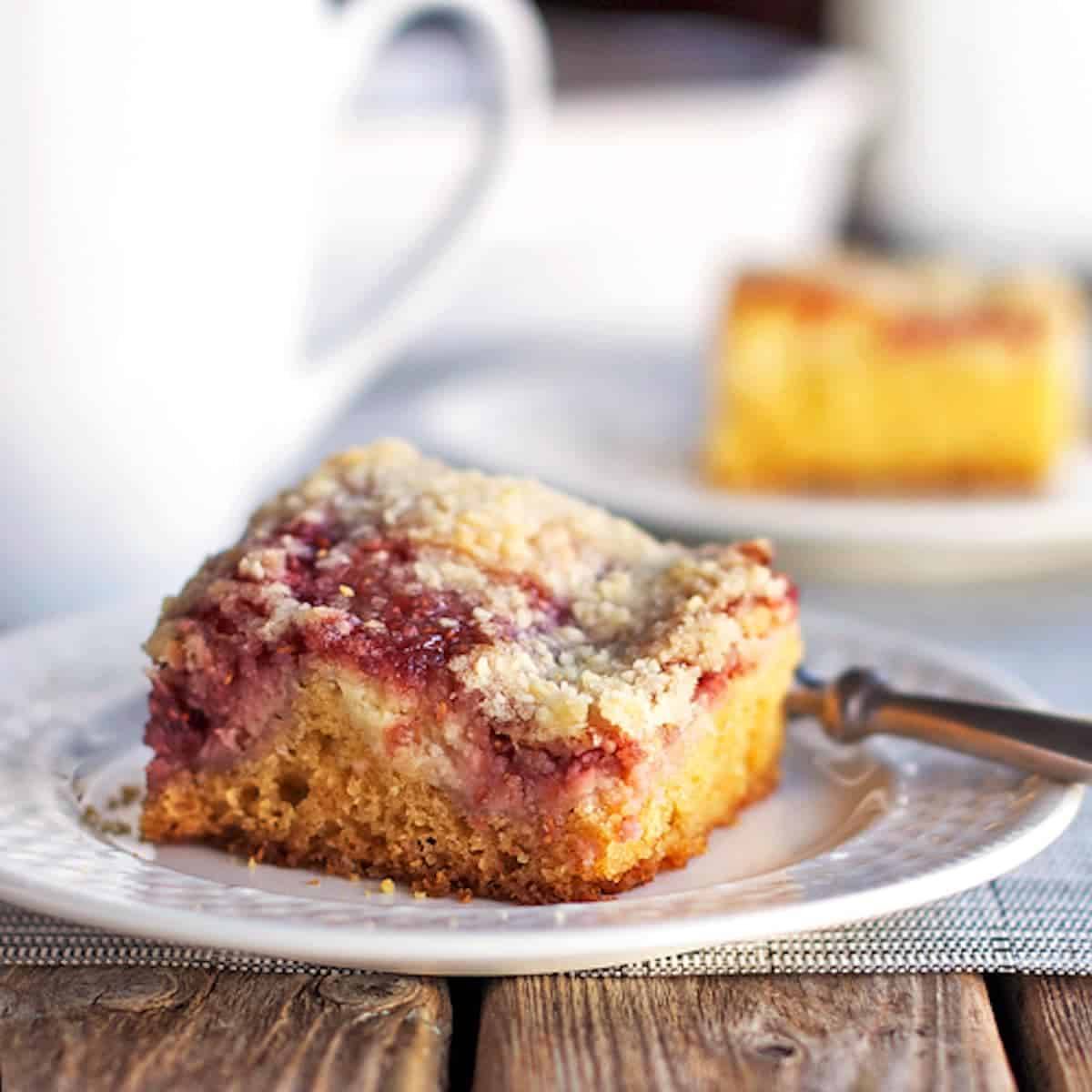 Raspberry cream cheese coffee cake on a plate with a fork.