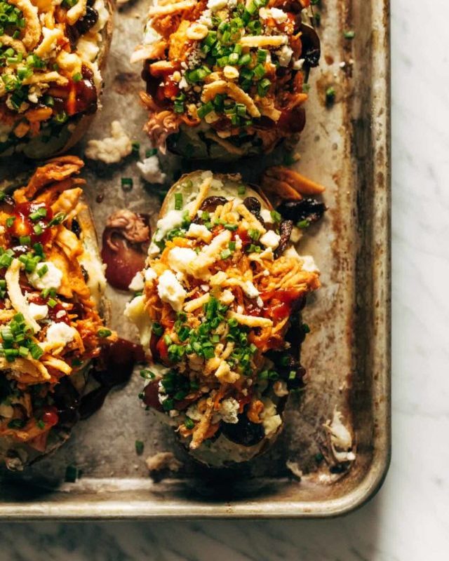Loaded BBQ Baked Potatoes on a sheet pan.