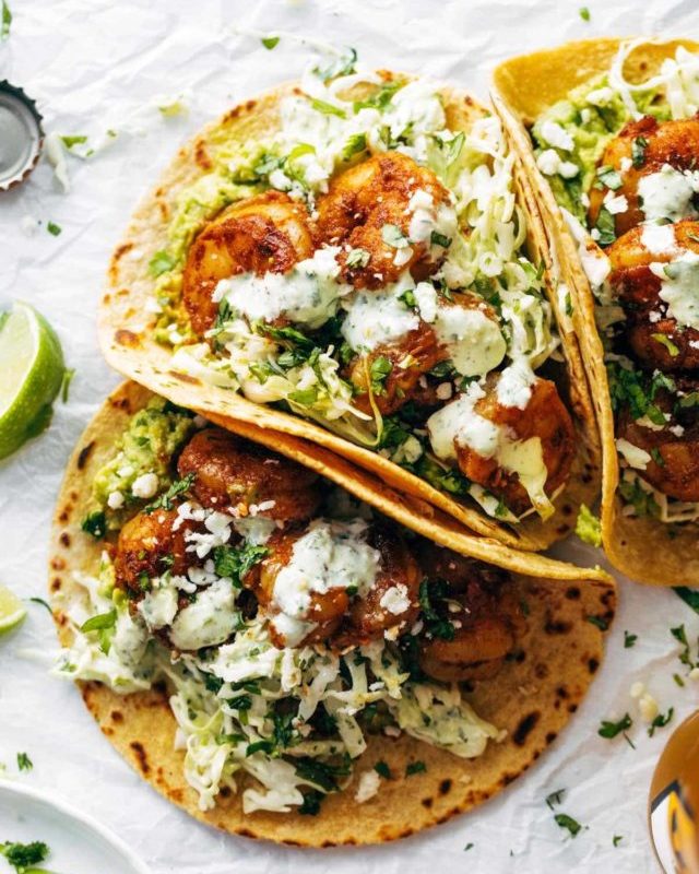 Spicy shrimp tacos with sauce.