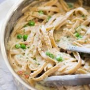 Lightened Up Fettuccine Alfredo in a pan with tongs.