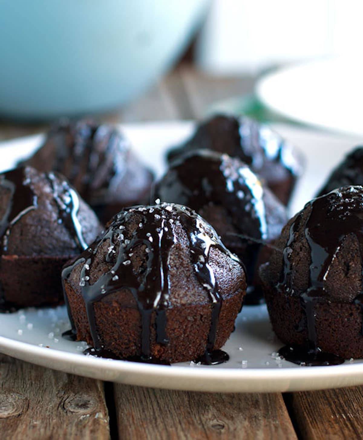 Salted double chocolate muffins with glaze on a plate.