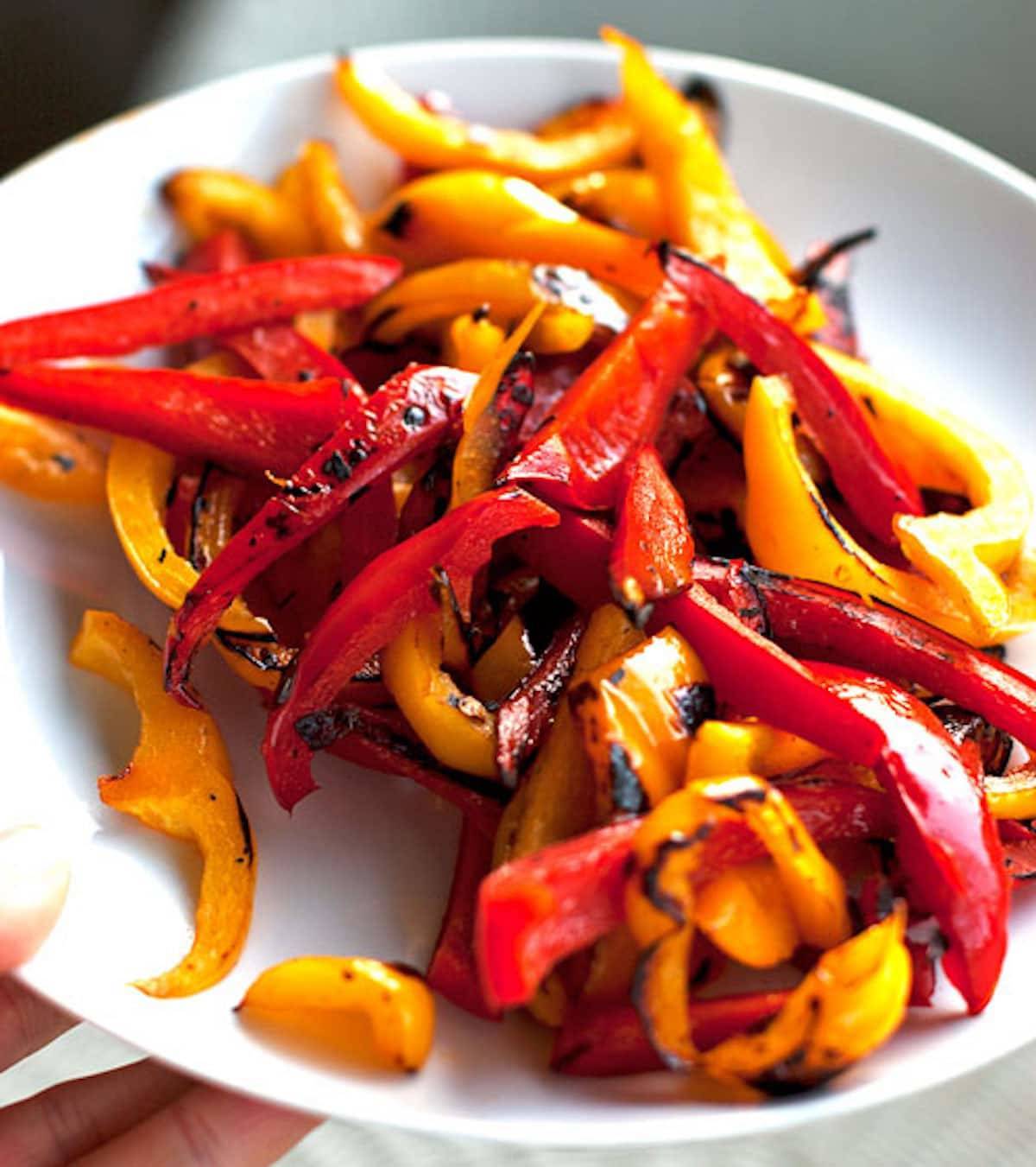 Fajita peppers on a white plate.
