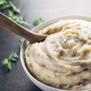 Easiest Garlic Mashed Potatoes - made entirely in the bowl of a slow cooker for easy prep and clean up! And that roasted garlic flavor - YUM.
