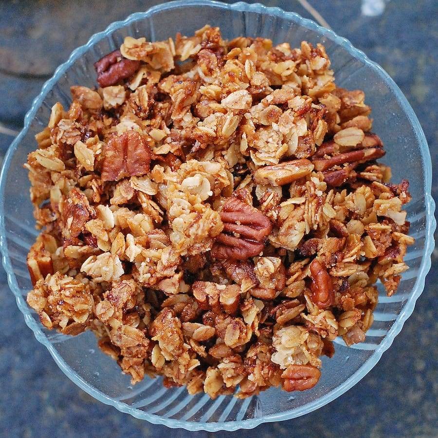 Pecan granola in a glass bowl.