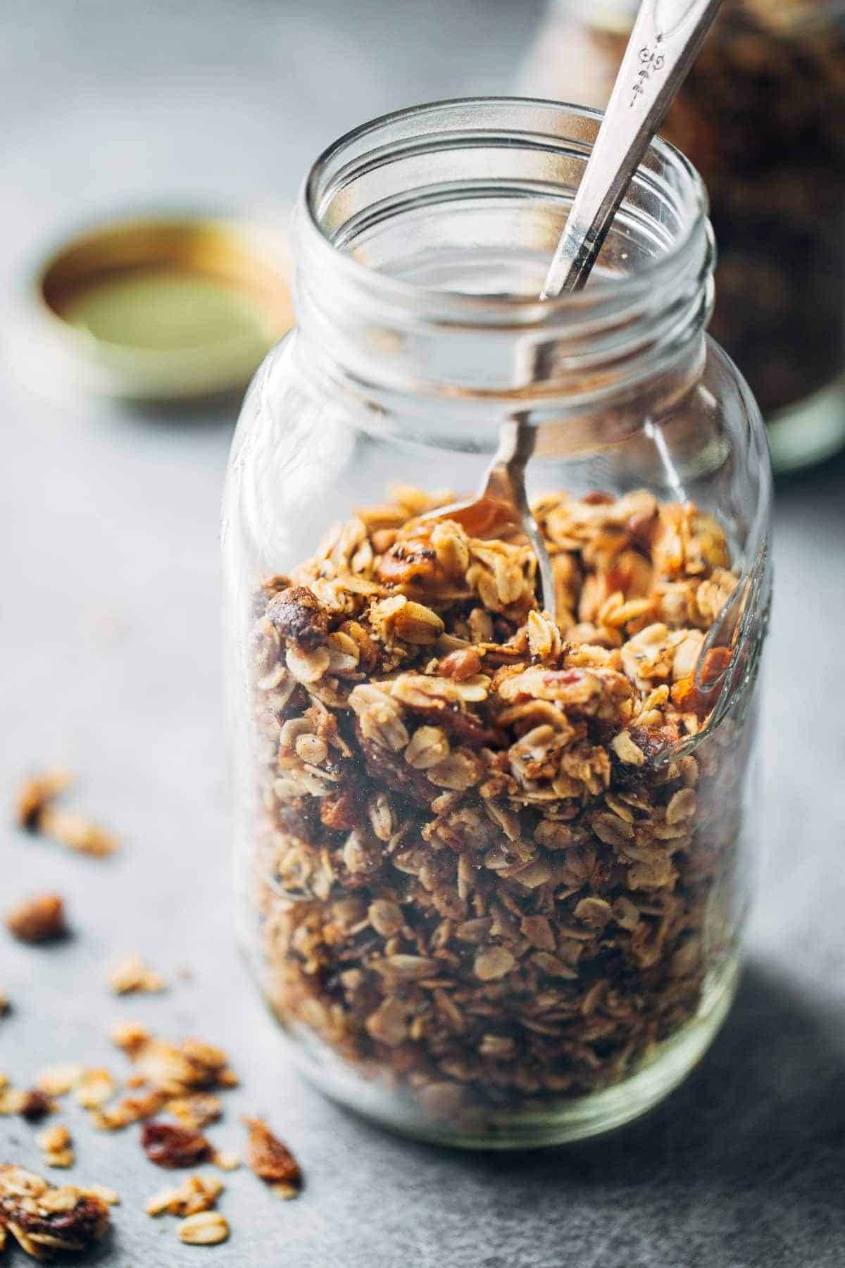 Granola in a jar with a spoon.