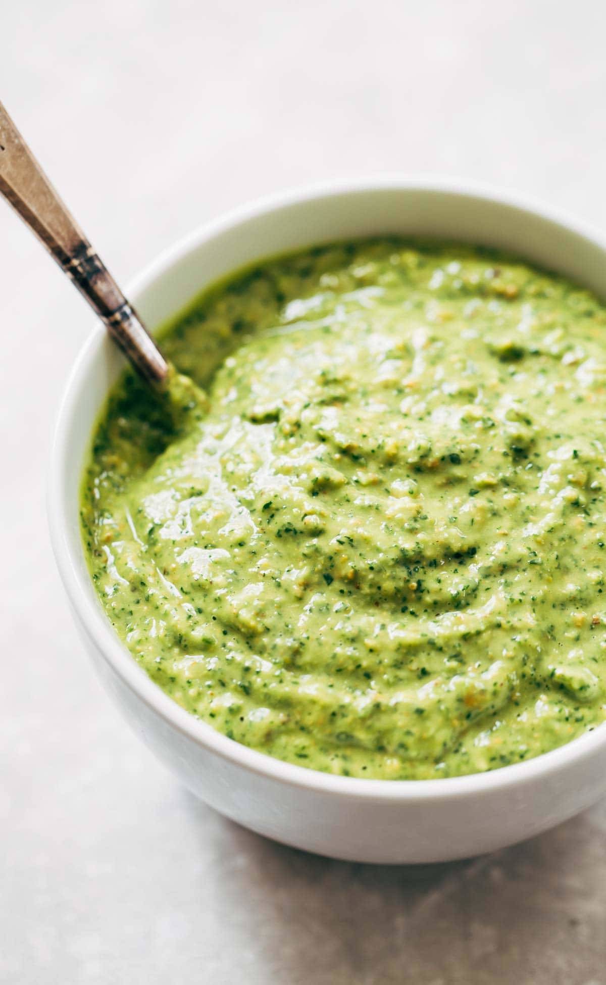 5 Minute Magic Green Sauce - SO AWESOME. Made with easy ingredients like avocado, olive oil, cilantro, lime, garlic, and parsley! Vegan. | pinchofyum.com