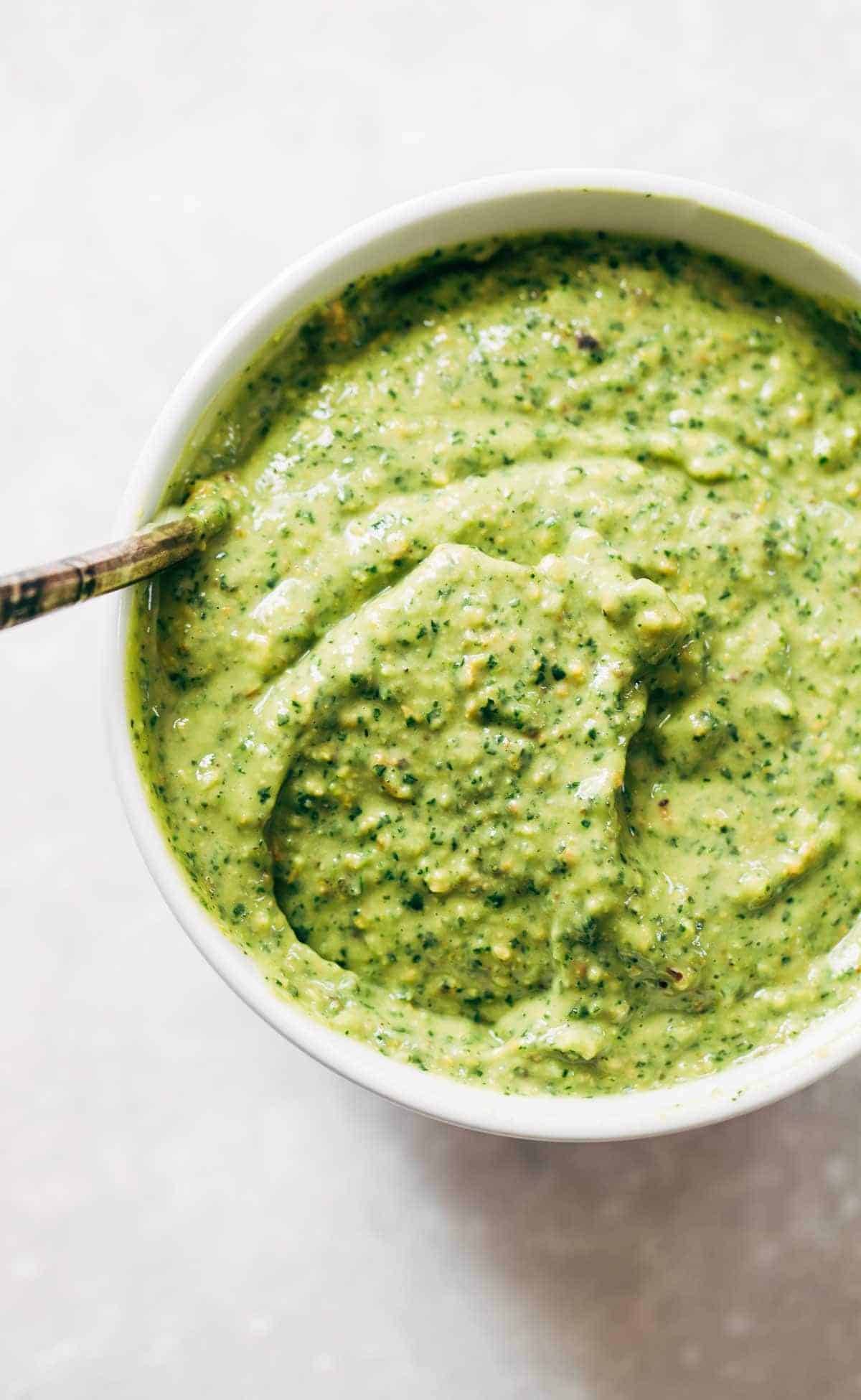 Magic green sauce in a white bowl.