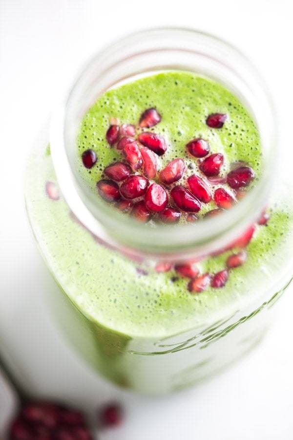 Holiday Detox Green Apple Smoothie in a jar with pomegranate arils on top