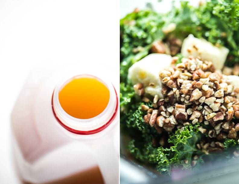 Juice in a bottle and kale with nuts in a blender.