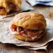 A picture of Hot Ham and Cheese Sandwiches with Bacon and Caramelized Onions