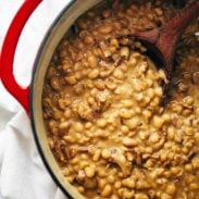 Homemade Brown Sugar Baked Beans in a pot with a spoon.