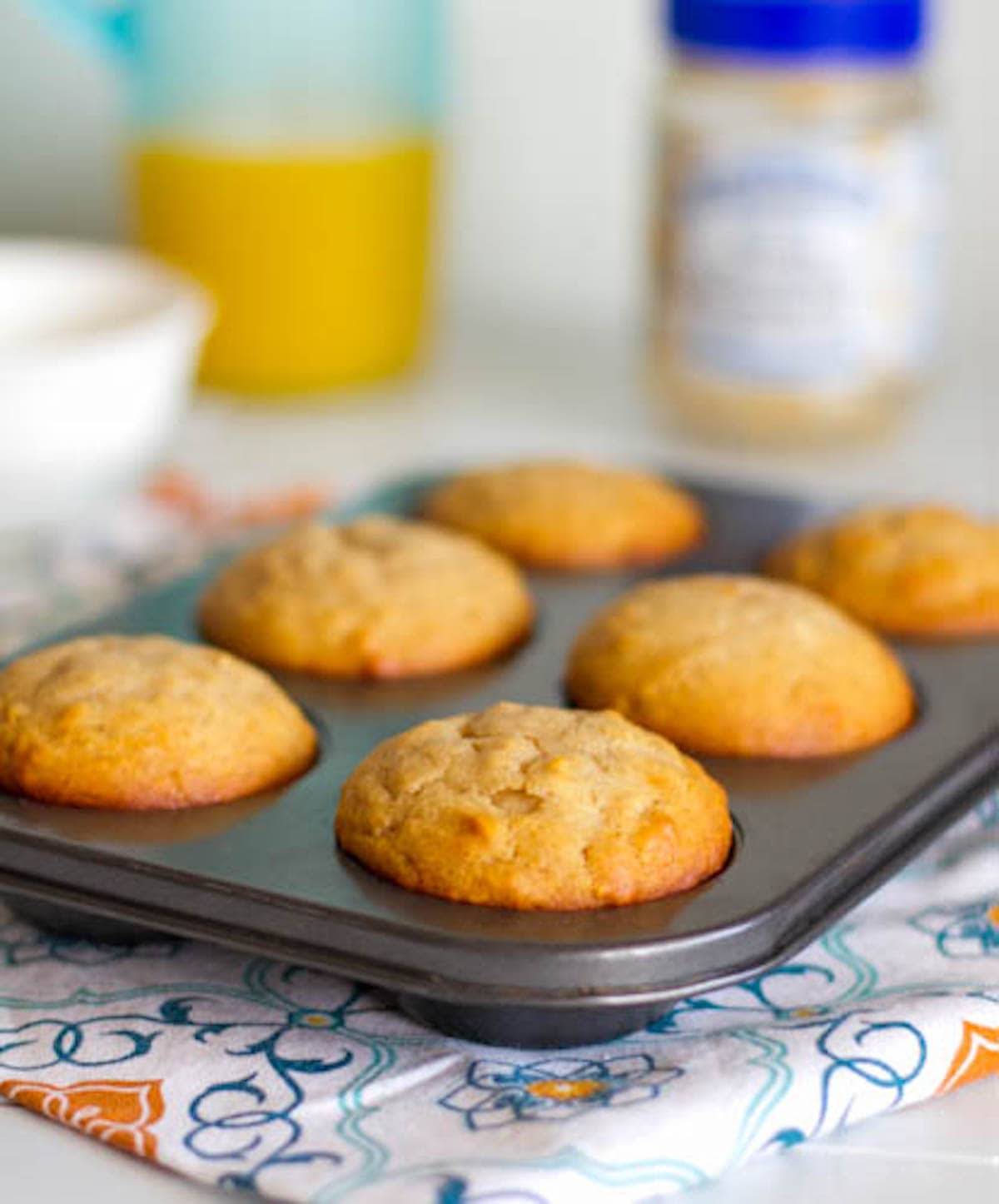Peanut butter and honey muffins in a baking tin.