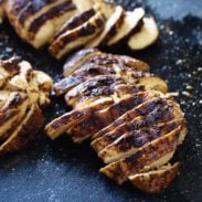 Jerk chicken sliced on cutting board.