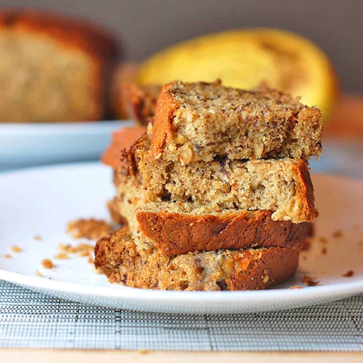Maple banana bread stacked on a plate.