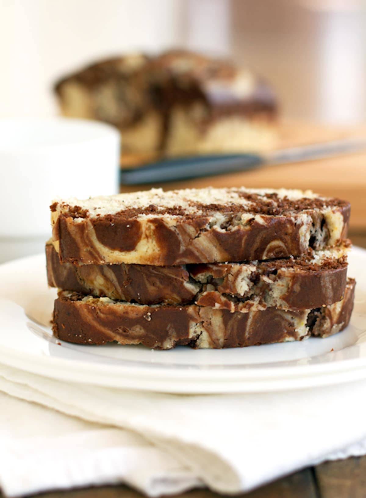 Chocolate and sweet cream marble loaf stacked on a plate.