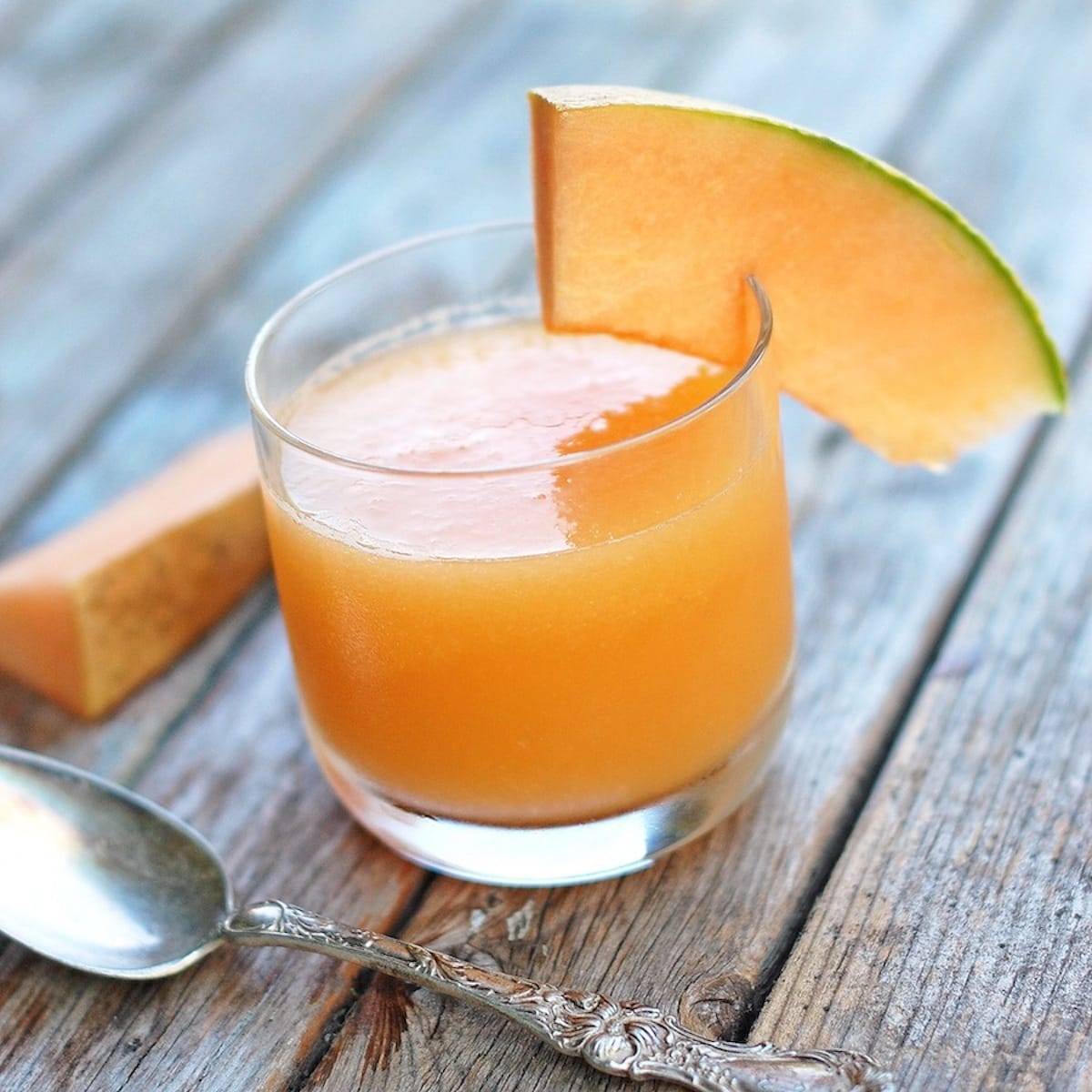Ginger Melon Chiller in a glass with cantaloupe and a spoon.
