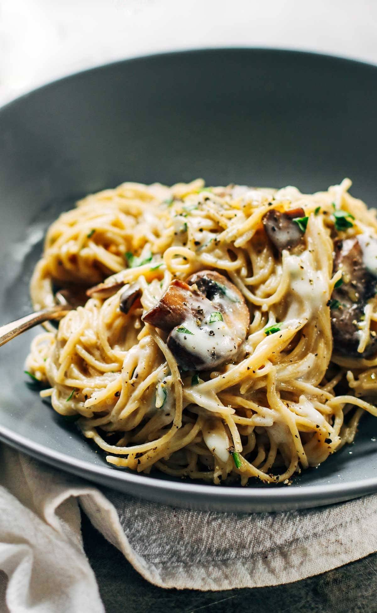 Creamy Garlic Herb Mushroom Spaghetti in a grey bowl.