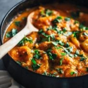 Spanish Chicken and Potatoes in a pot with a spoon.