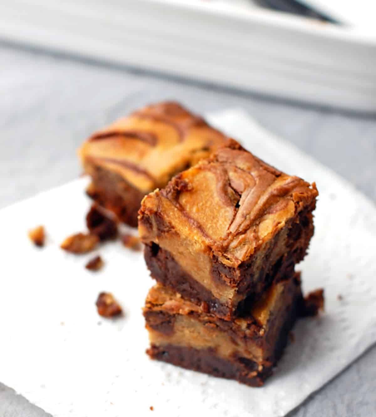 Peanut butter cheesecake brownies on a napkin.