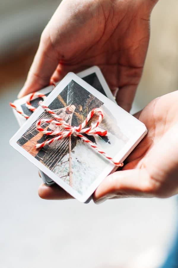 Small photo prints tied with red string.
