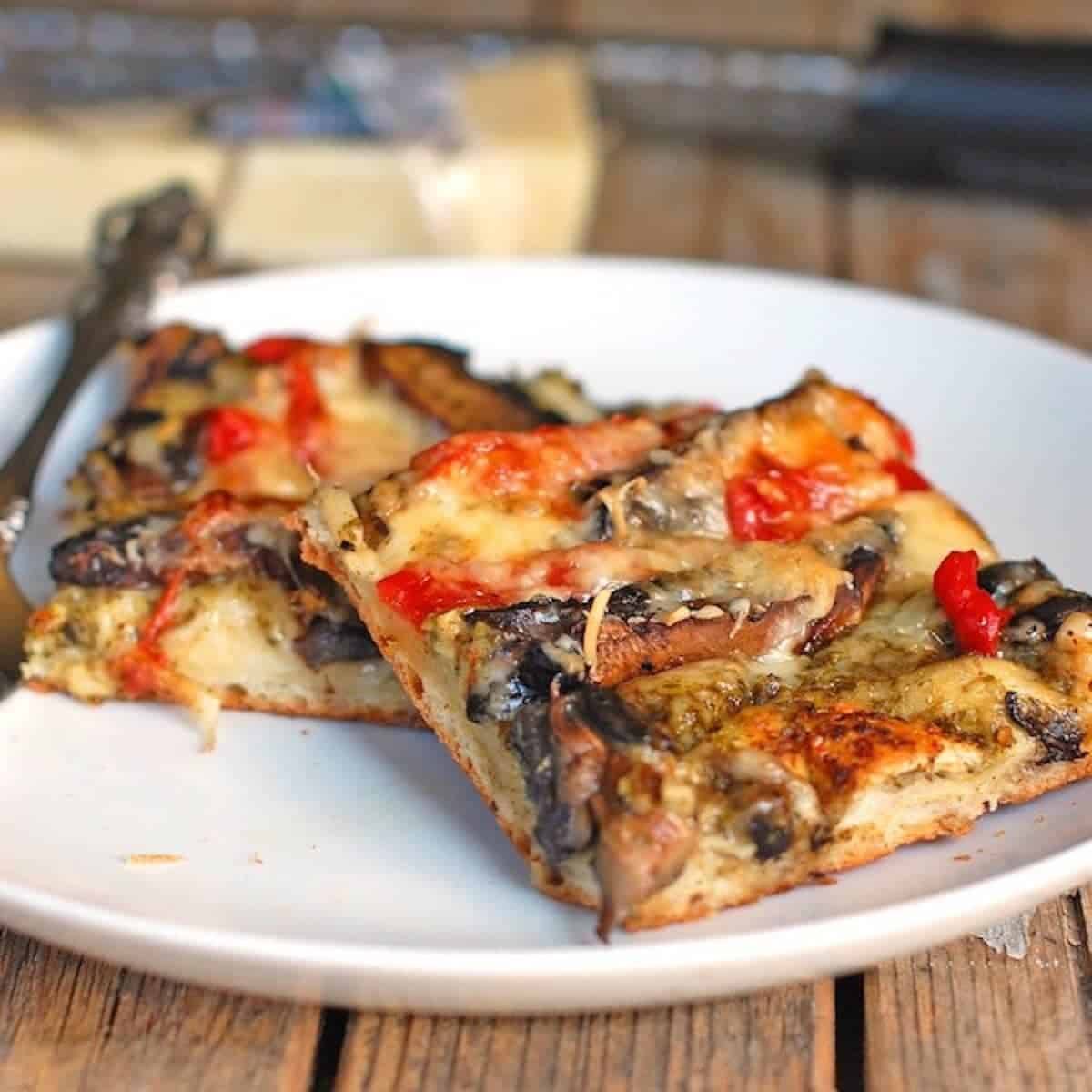 Pesto pizza with portobello mushrooms and red peppers. 