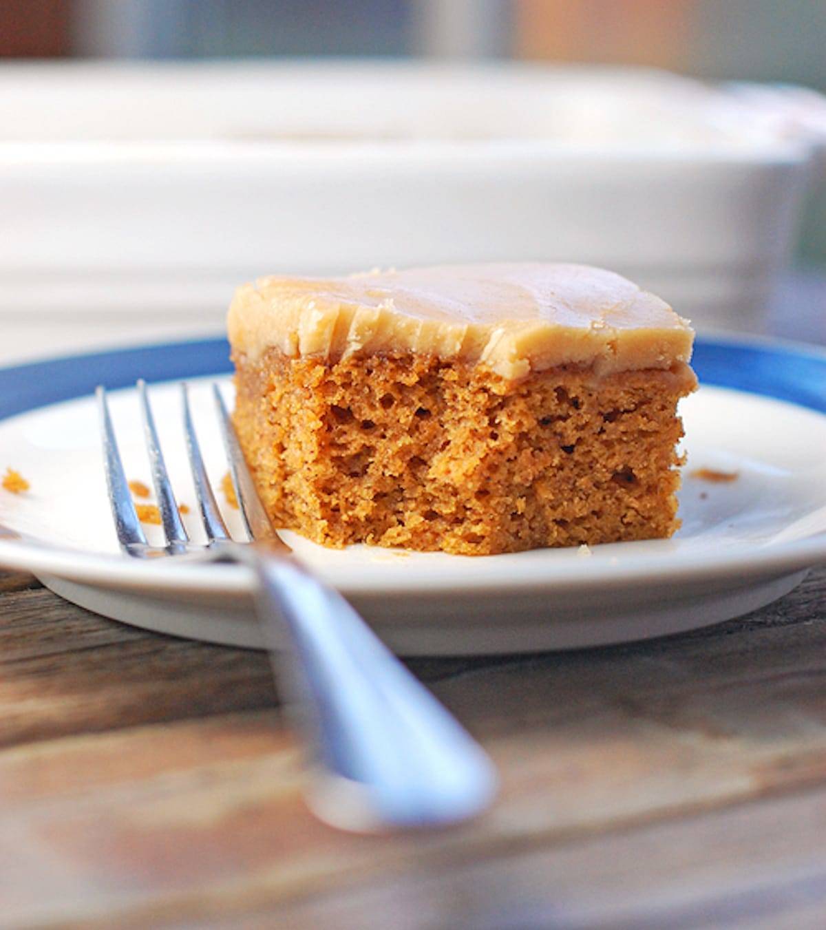 Pumpkin bar topped with this old-fashioned caramel frosting on a plate with a fork.