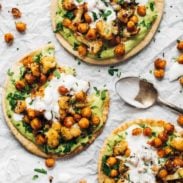 Roasted Veggie Pitas with Avocado Dip on parchment paper.