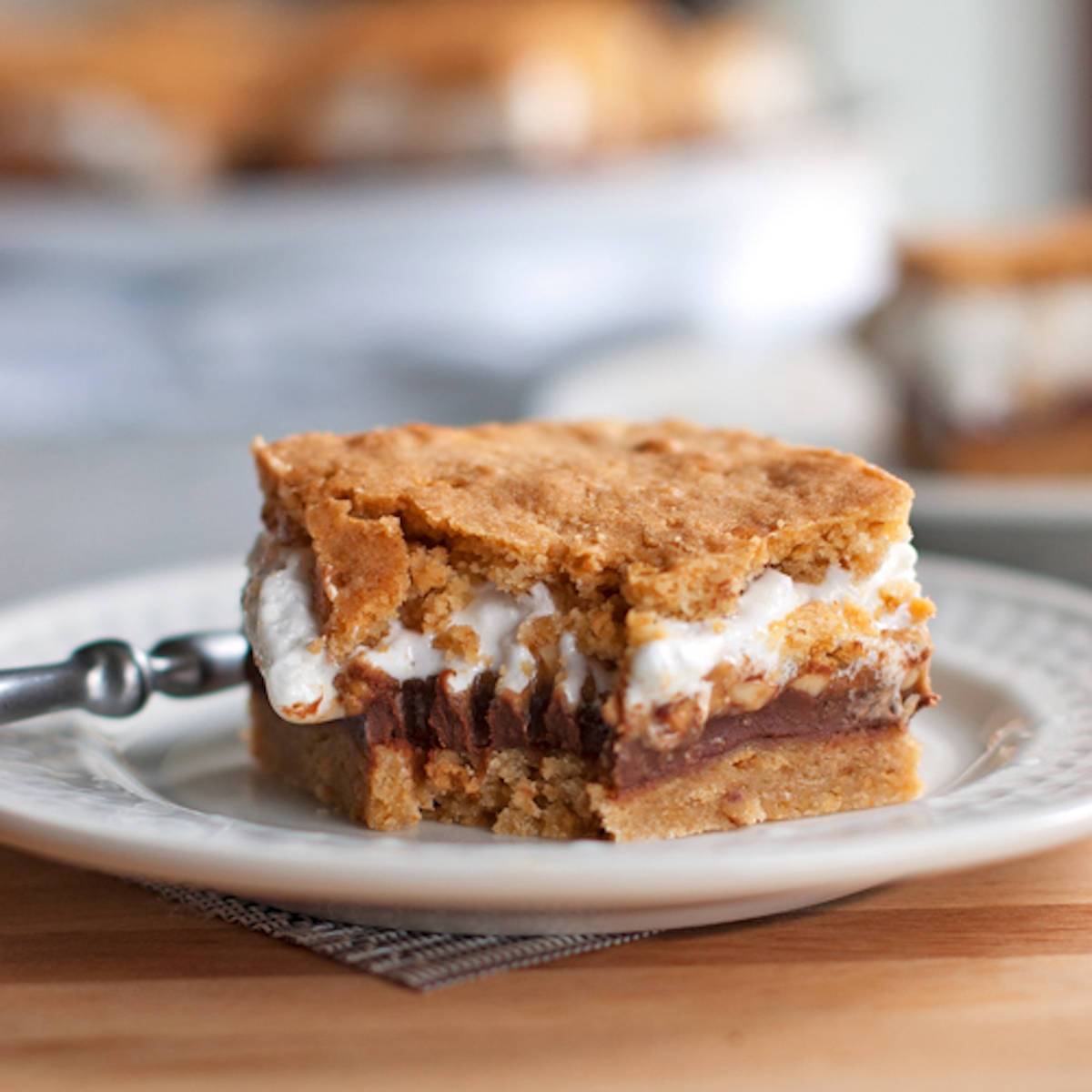 One s'mores bar layered in between marshmallow fluff, chocolate, and a graham cookie base. 