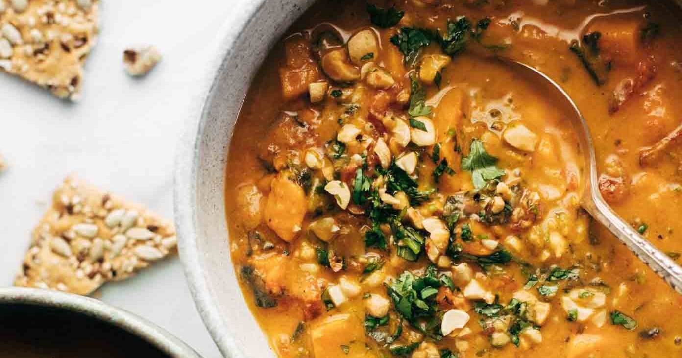 Spicy Peanut Soup with Sweet Potato + Kale via Pinch of Yum