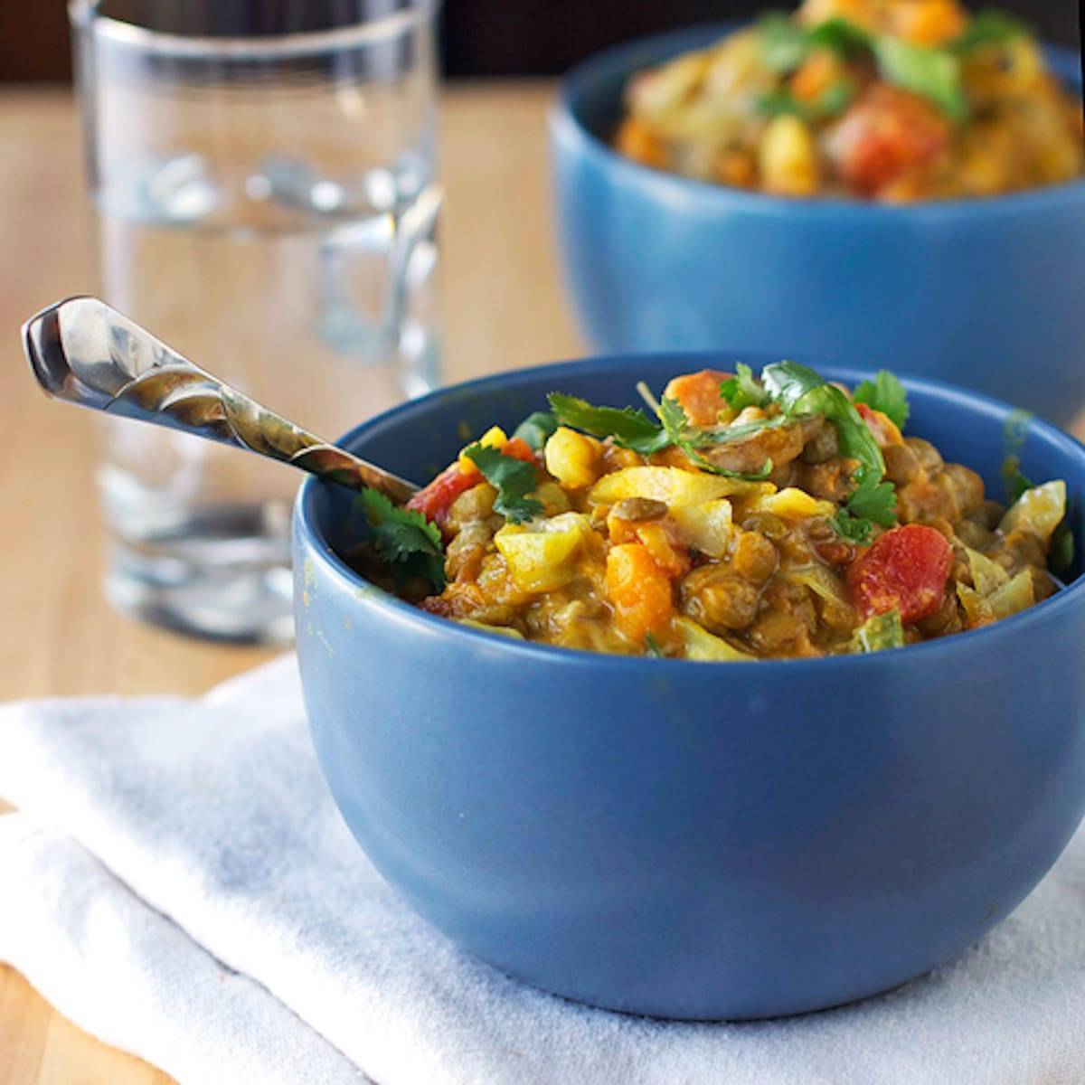 Creamy Thai sweet potatoes and lentils in a blue bowl.