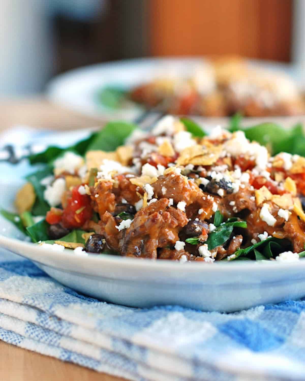Tex-mex taco salad topped with tex-mex style ground beef.