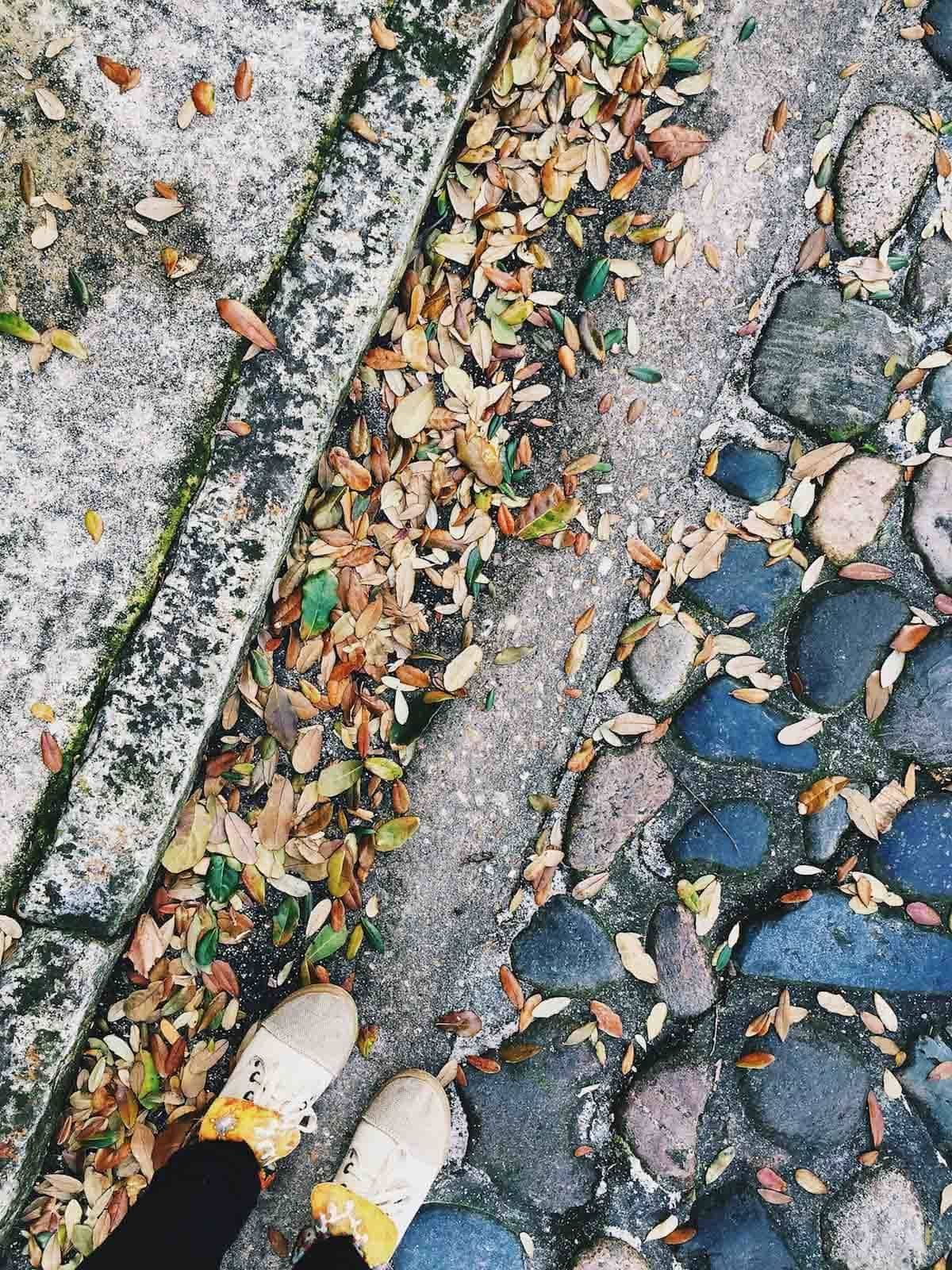 Feet on the sidewalk.