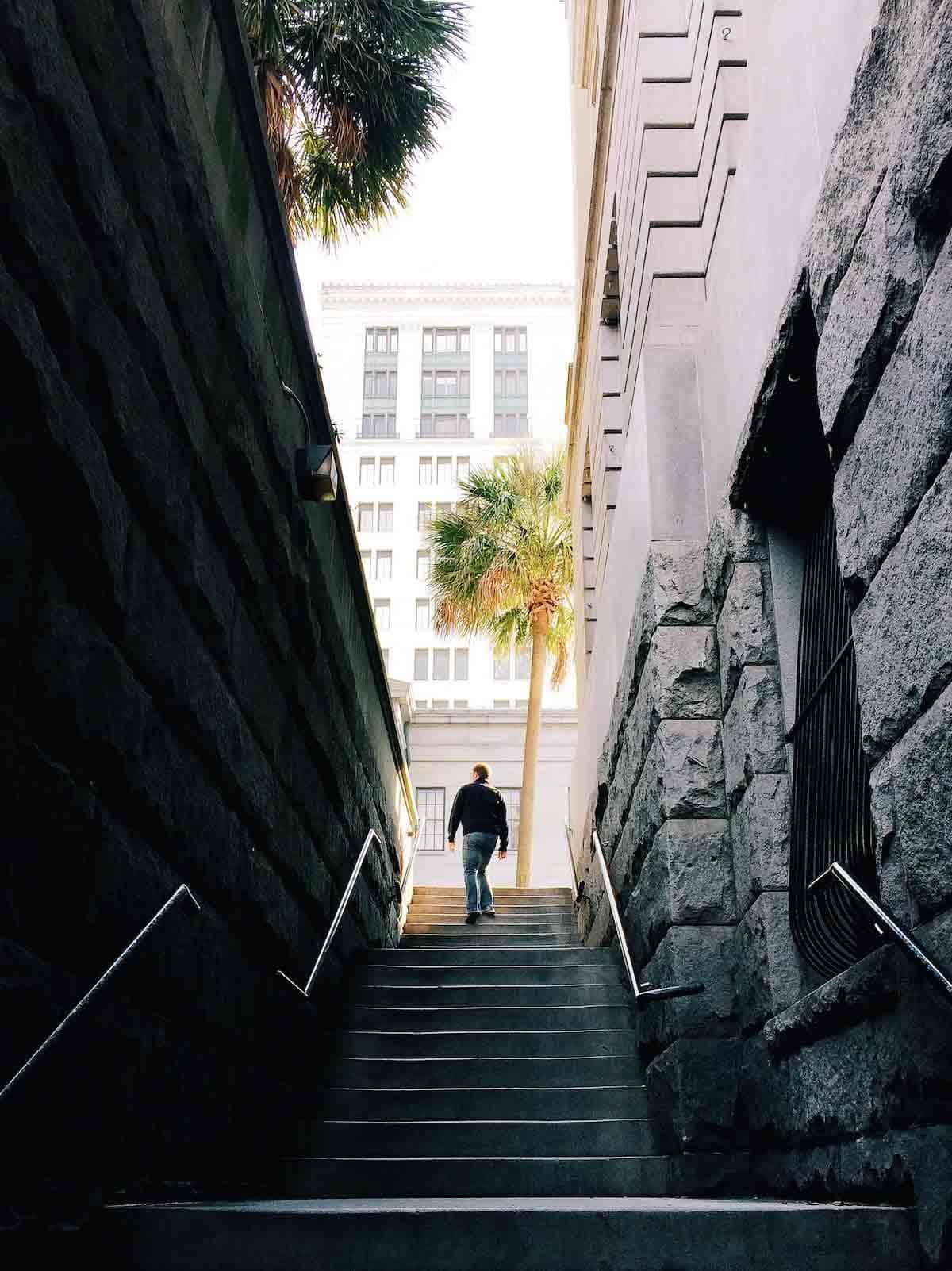 Man walking up stairs.
