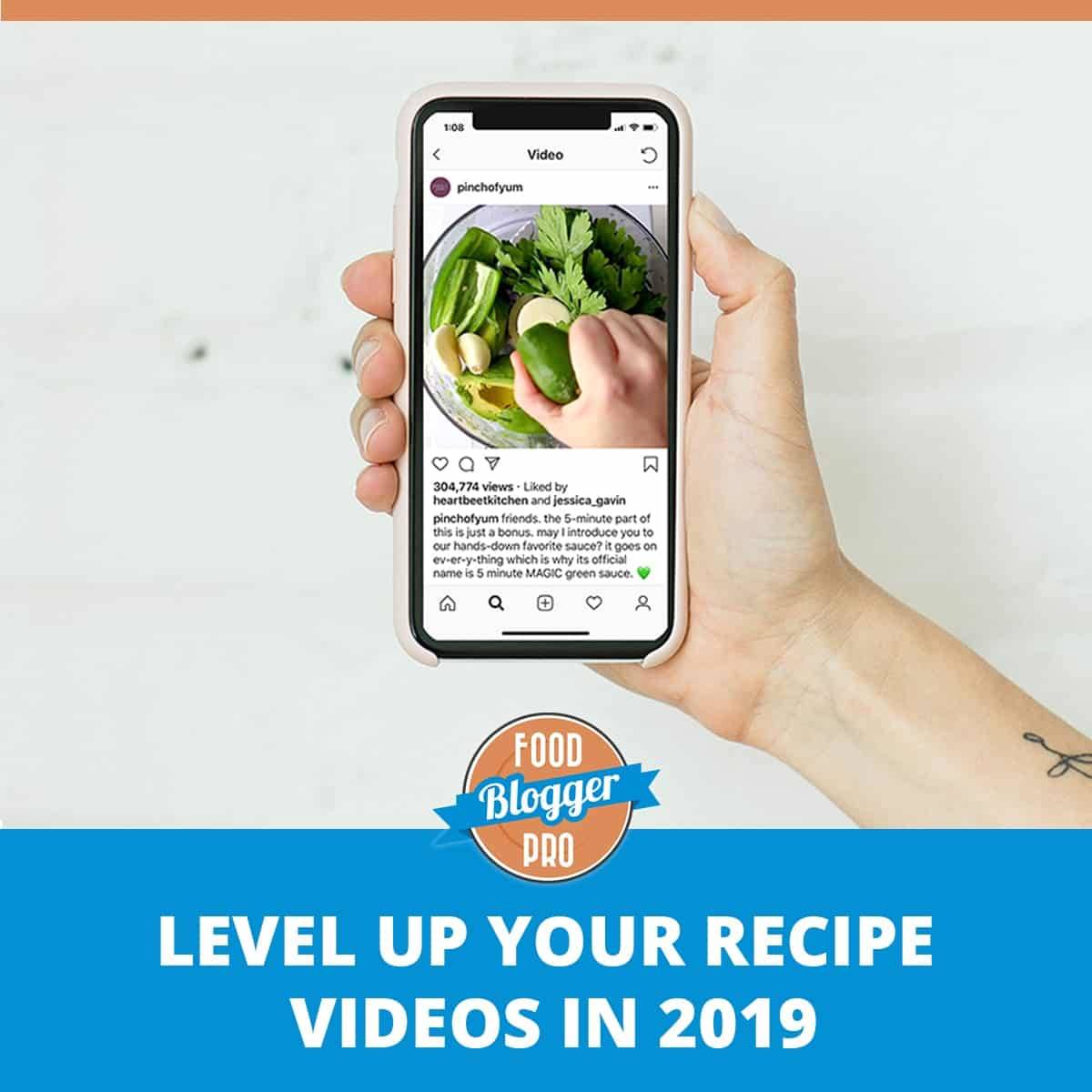 Hand holding iPhone with level up your recipe videos in 2019 graphic.